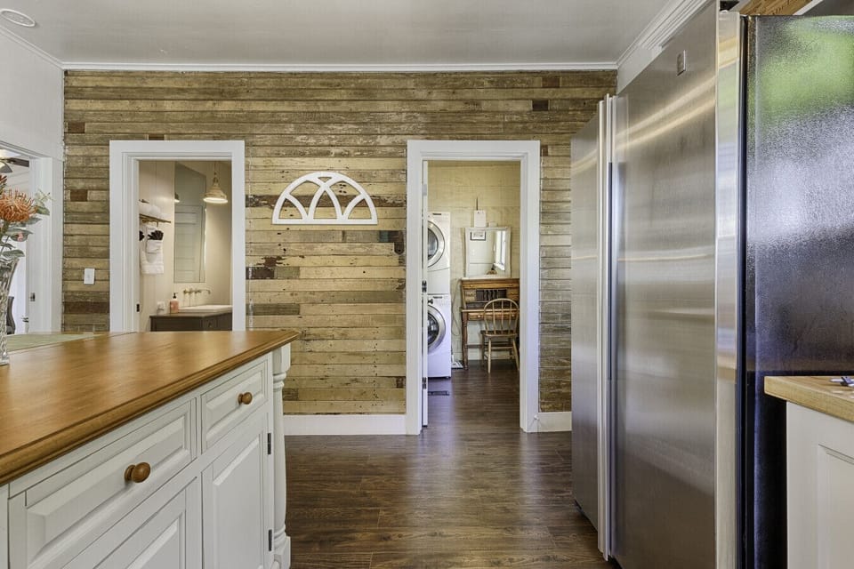 Kitchen connecting to bathroom and workstation/laundry room