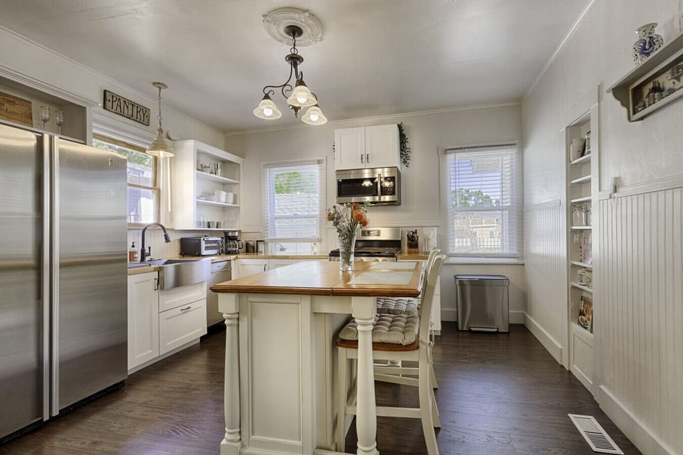 Chef`s kitchen with stove, microwave, island, and dishwasher