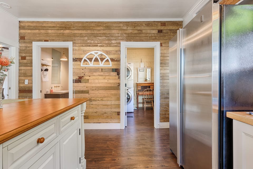 Kitchen connecting to bathroom and workstation/laundry room
