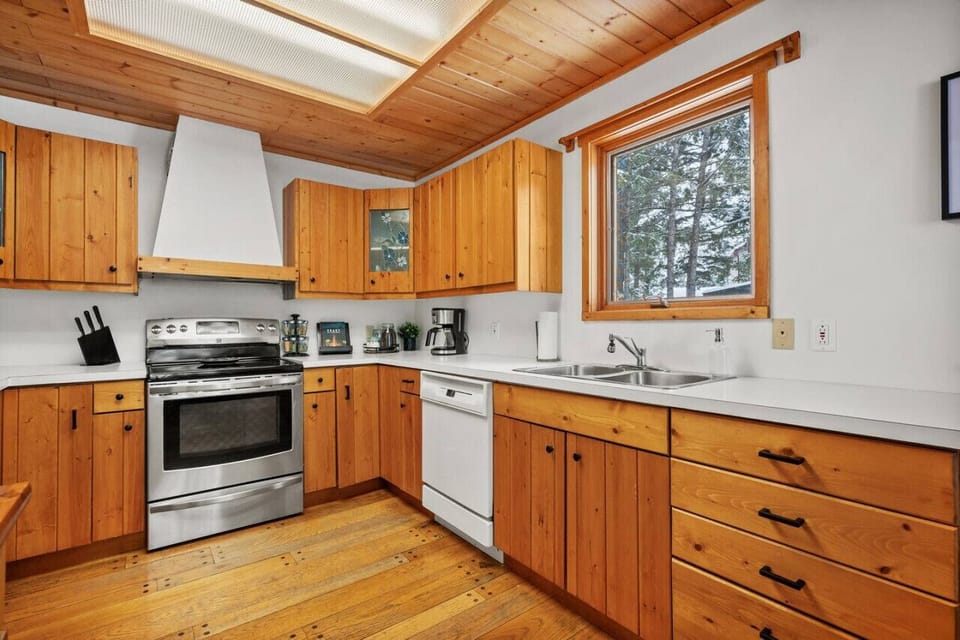 Full kitchen with a drip & espresso coffee machine and a kettle.
