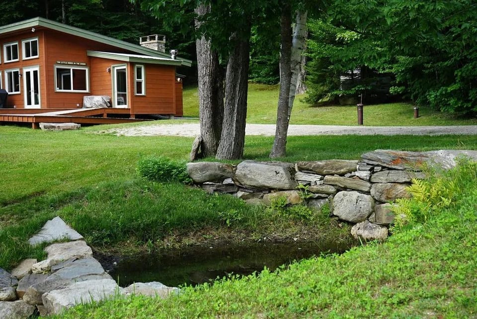 Private driveway with ramp to enter house. Gently babbling stream in the front