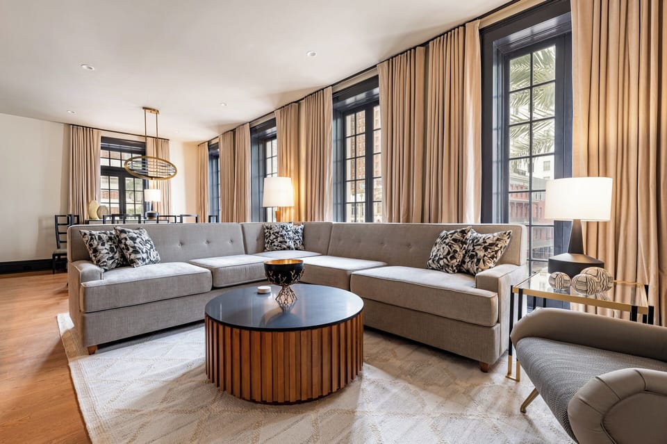 Stylish living area featuring charming windows that flood the space with natural light and offer captivating views of Canal Street.