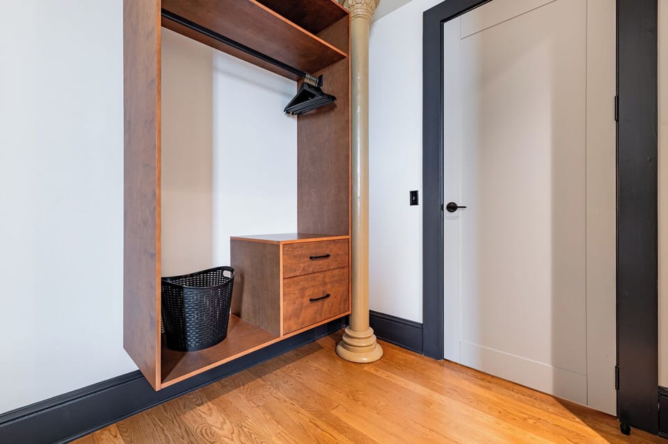 Bedroom 3 - Closet space equipped with hangers and laundry hamper.