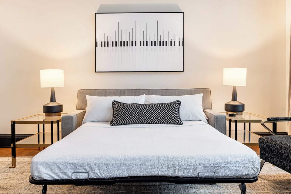 Living room sofa doubles as a queen-size sleeper, offering additional sleeping accommodations for guests.