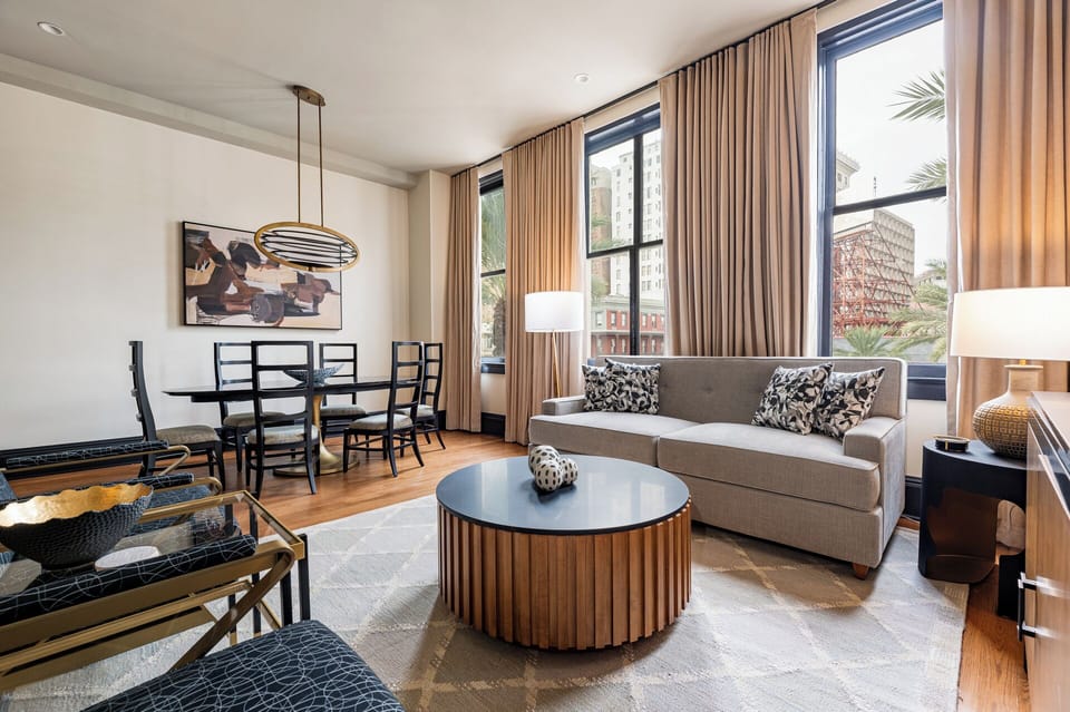 Sophisticated living area with expansive Canal Street views, highlighted by tall windows that bring in plenty of light and capture the city's energy.