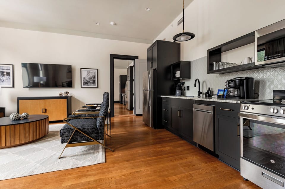 Open connection to a second unit featuring another full kitchen, living area, and additional bedrooms, providing ideal space for group stays or family gatherings.
