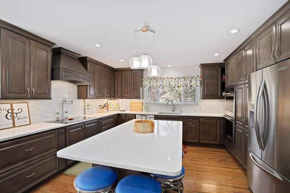 The kitchen is updated with double ovens and stainless appliances. 
