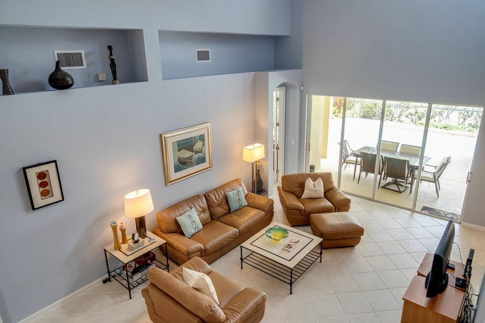 The 2-story main living area is furnished in comfortable leather furnishings.