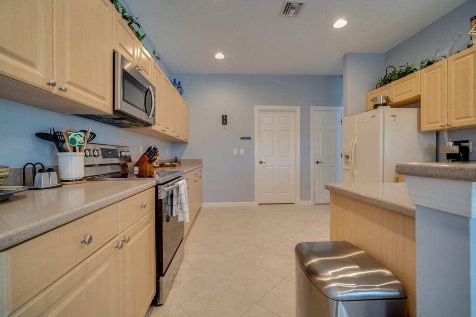 Cookware, dinnerware, many kitchen tools and small appliances are provided.