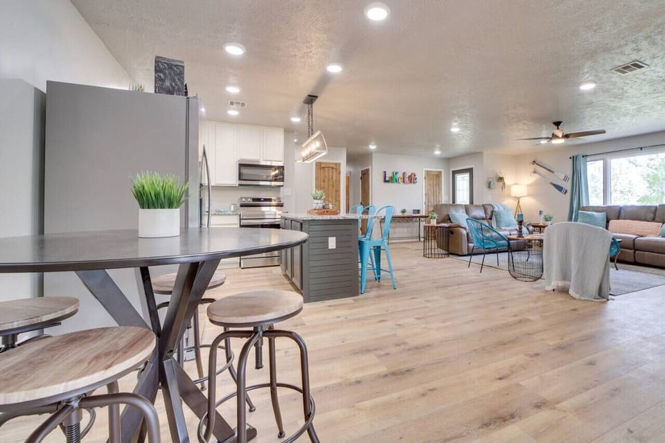 Open concept kitchen and living, bar seating for 3 and pub table with seating for 4
