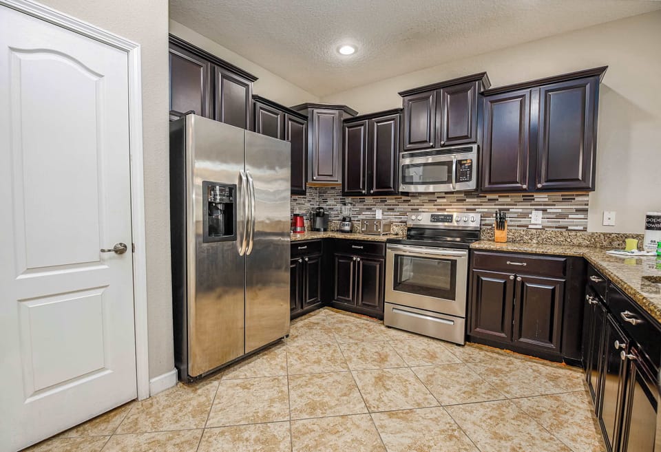 Cook with ease in the fully equipped kitchen featuring modern appliances and ample counter space.