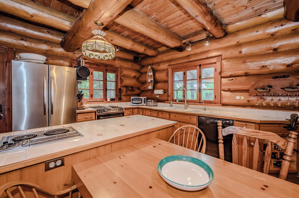A chef’s delight, the kitchen offers ample counter space, modern appliances, and a central island perfect for meal preparation or gathering with loved ones.