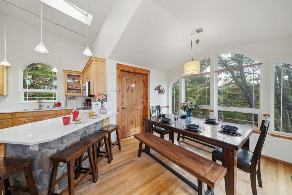 Open living space with,Kitchen with breakfast bar, dining room and  Living room with Gas fireplace, Roku TV, and access to upper deck.