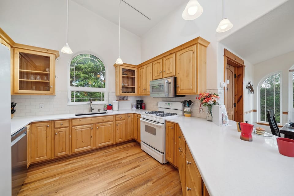 Open living space with,Kitchen with breakfast bar, dining room and  Living room with Gas fireplace, Roku TV, and access to upper deck.