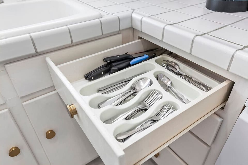Fully equipped kitchen with all cooking and dining supplies for your comfort, including complimentary coffee, tea, creamer, spices, and cleaning supplies