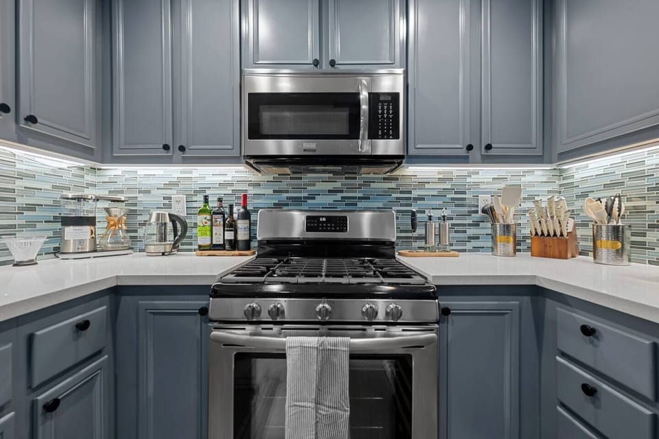 Our sleek metal appliances include a gas stove with oven, microwave, and more, providing everything you need for a modern and efficient cooking experience.