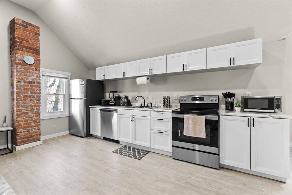 A brand-new kitchen with modern appliances, sleek cabinets, and stylish countertops, seamlessly integrated into the open-concept living area.