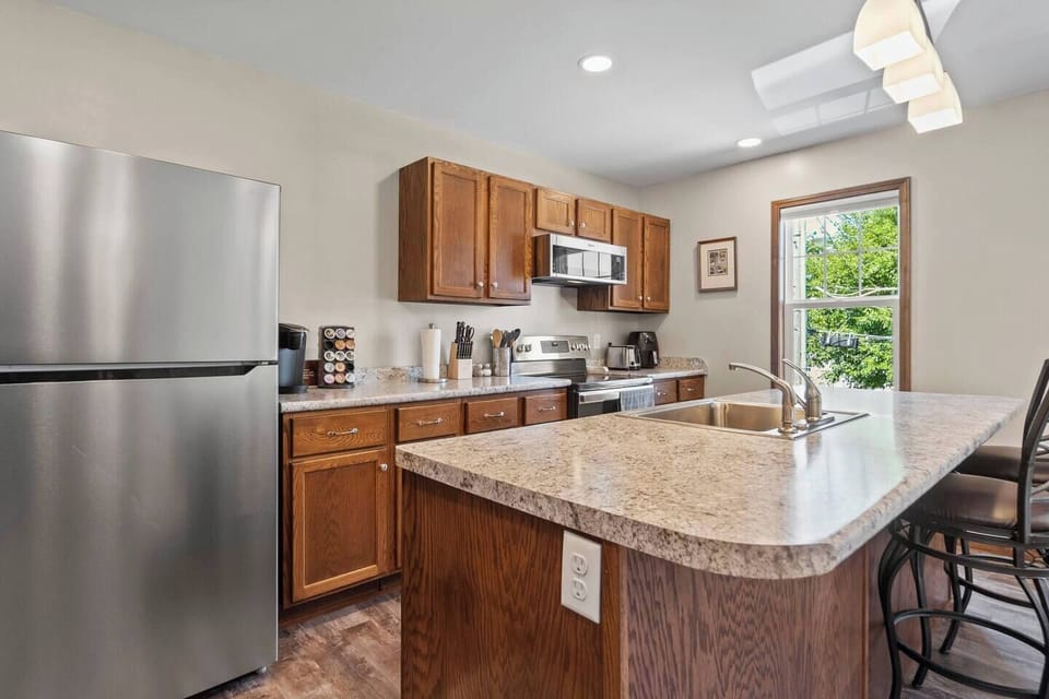Full kitchen view showcasing modern appliances, a spacious countertop, and plenty of storage, perfect for cooking and entertaining.