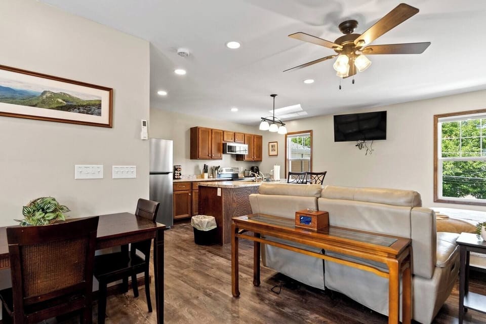 Spacious living area with a TV, comfortable couches, and direct access to the dining area, creating a seamless flow for relaxation and meals.