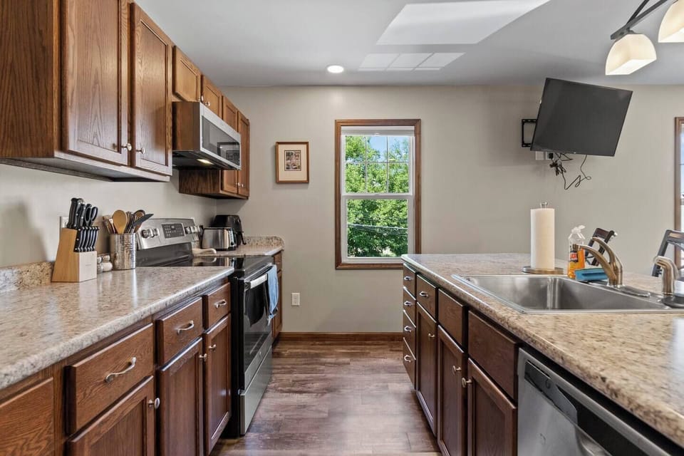 Fully equipped kitchen with a spacious countertop and ample cabinets, providing plenty of storage and space for all your cooking needs.