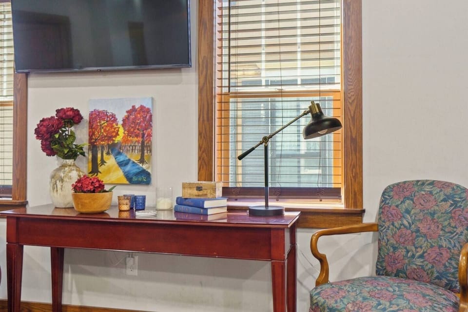 TV setup with a stylish table, lamp, and comfortable seating, creating a cozy and functional entertainment space.
