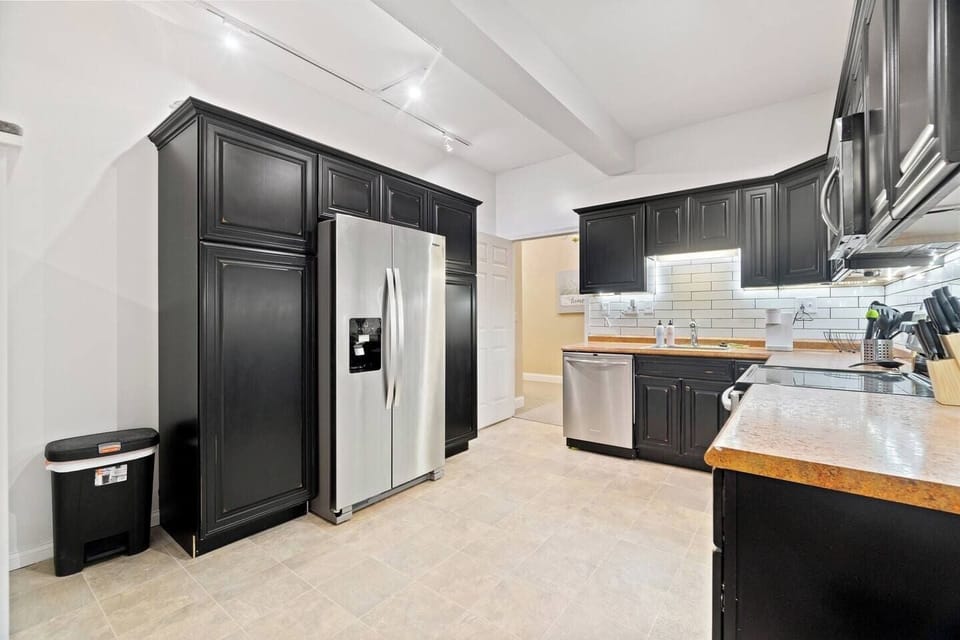 Spacious kitchen featuring a large refrigerator seamlessly integrated with stylish kitchen cabinets for a sleek and functional design.