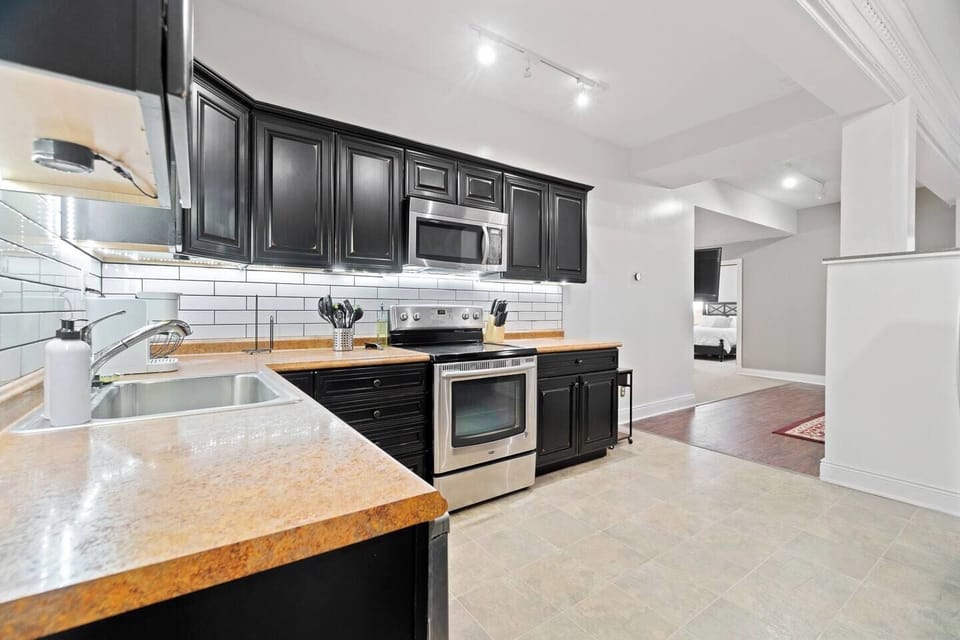 Stylish and elegant kitchen cabinets complemented by modern kitchen appliances, offering both functionality and a sleek design for your cooking needs.