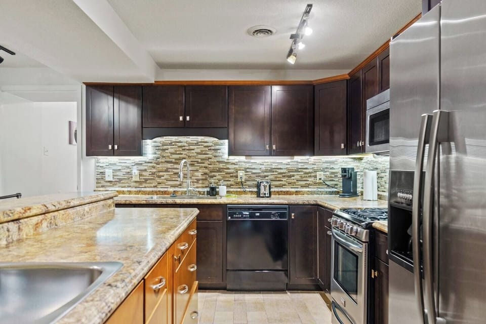 Modern kitchen featuring stylish drawers and a large fridge, providing both functionality and a sleek design for all your cooking needs.
