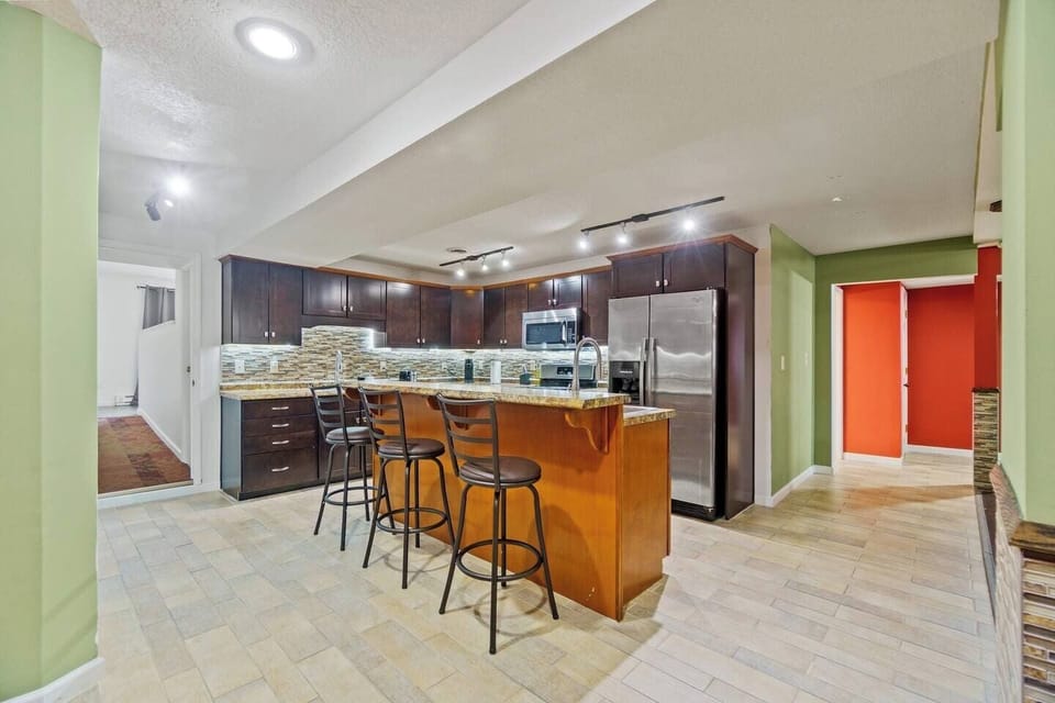 Kitchen countertop with seating for three, offering a casual spot for meals or socializing while you cook.