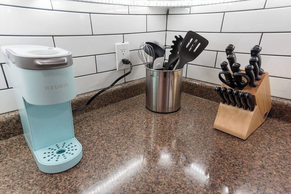 Well-equipped kitchen with a coffee maker, knife set, cooking tools, and a Keurig for your convenience and comfort.