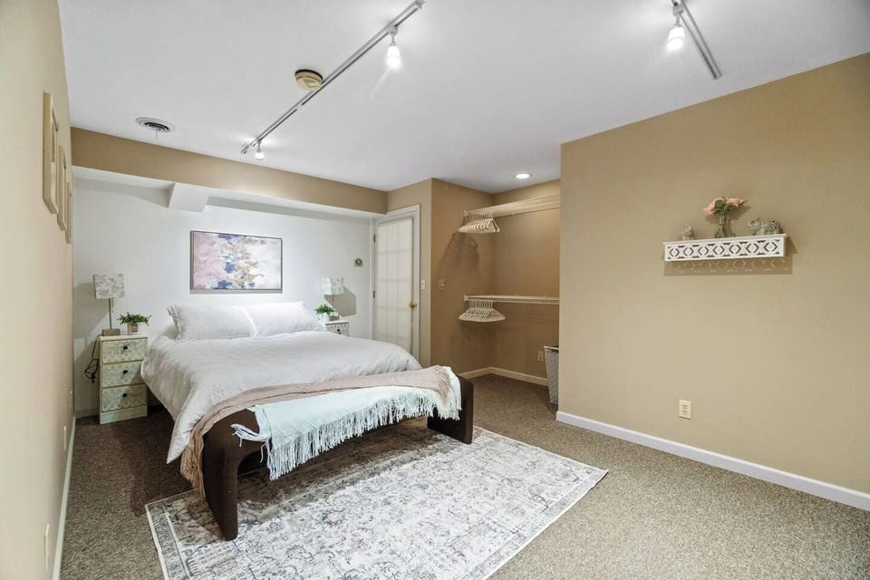Spacious queen-sized bedroom featuring a dresser or closet, offering ample storage and a comfortable retreat for restful nights.