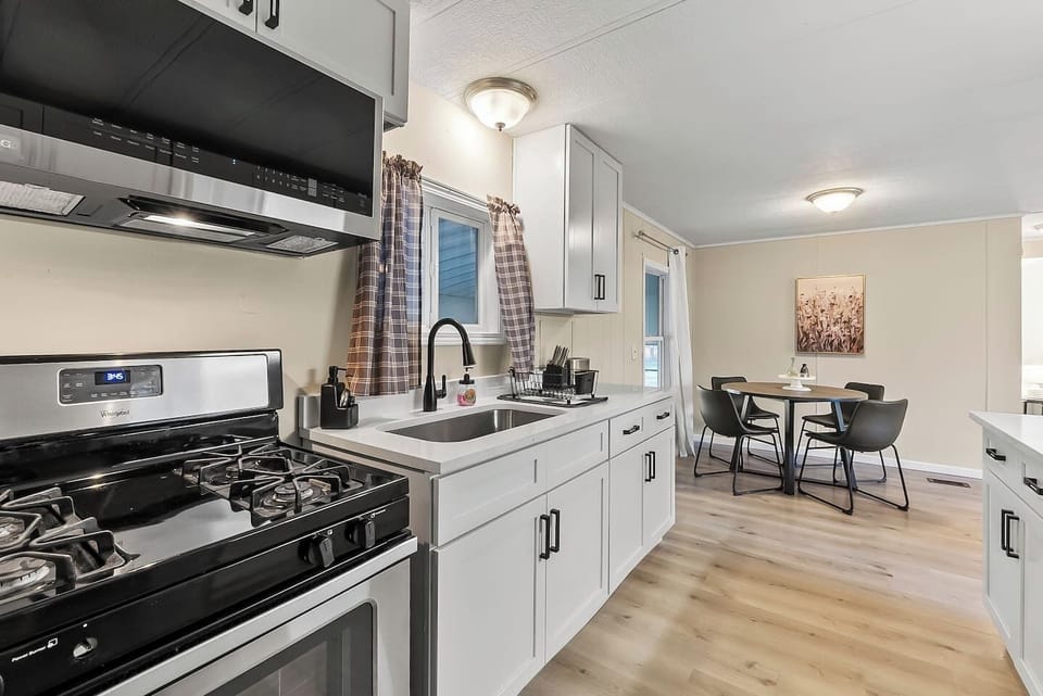 Bright kitchen with gas stove and deep sink, making meal prep simple and convenient.