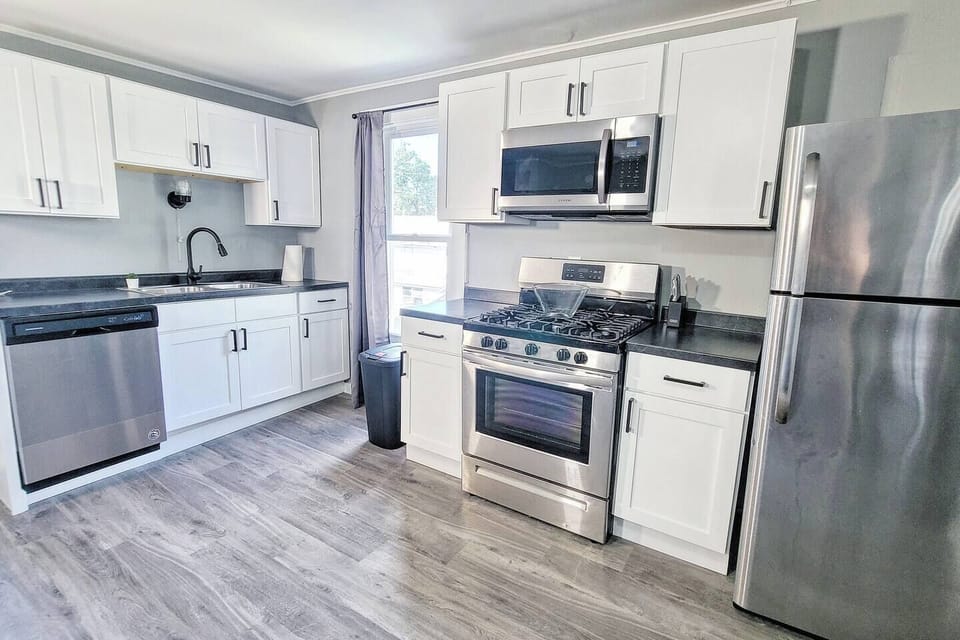 Modern full kitchen featuring sleek stainless steel appliances, ample counter space, and all the essentials for a seamless cooking experience.