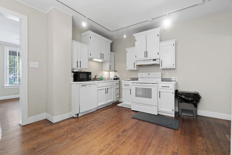 Elegant, modern kitchen with all-white interiors, featuring sleek countertops, contemporary appliances, and a minimalist design that creates a bright and airy cooking space.
