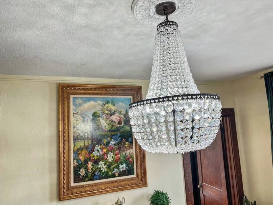 Elegant chandelier hanging above the dining table, adding a touch of sophistication and ambiance to your meals.