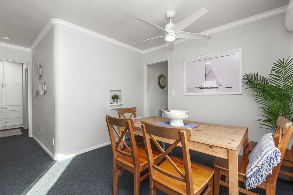 Dining area with seating for six people.  Apartment includes mini-split unit for AC, heating, and ceiling fan for air flow.