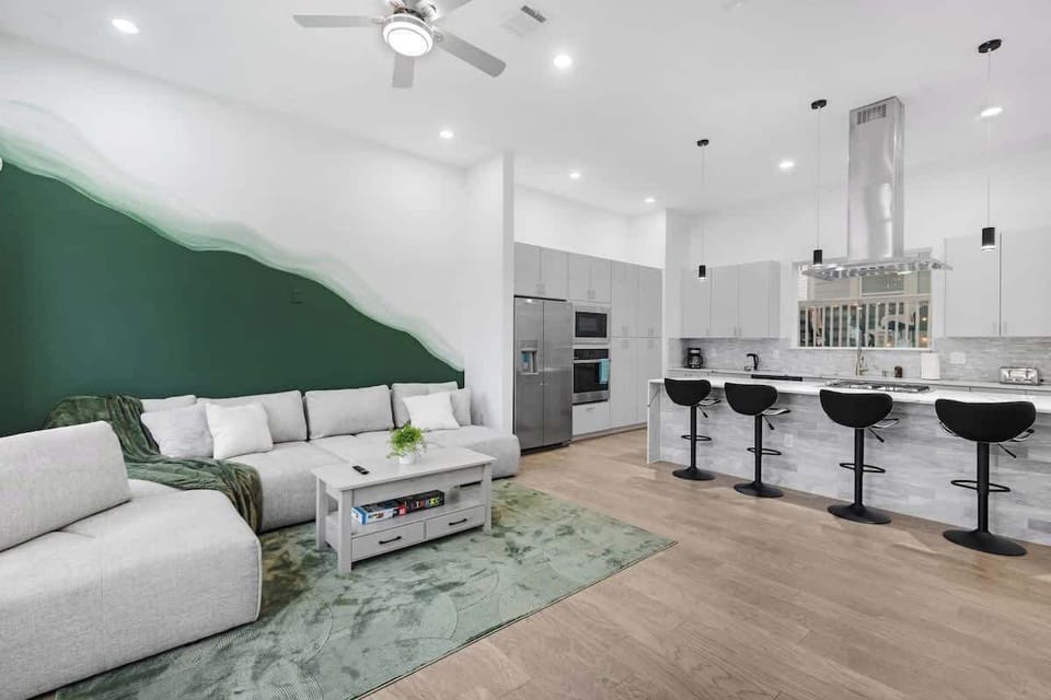 Open living & dining space w/ cohesive design, soft lighting & room to gather comfortably.