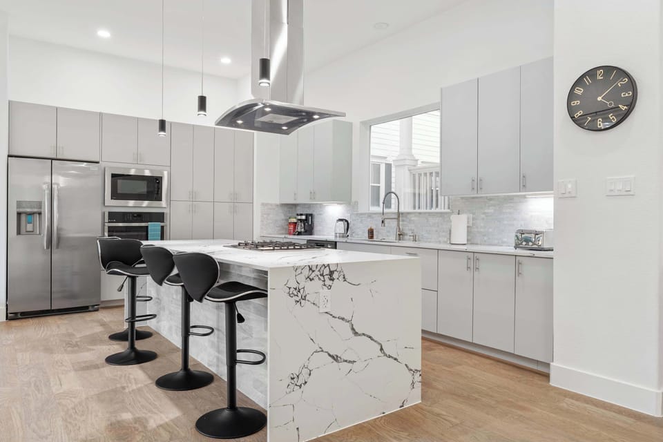Open kitchen w/ island seating, pendant lighting & a layout that keeps everything within easy reach.