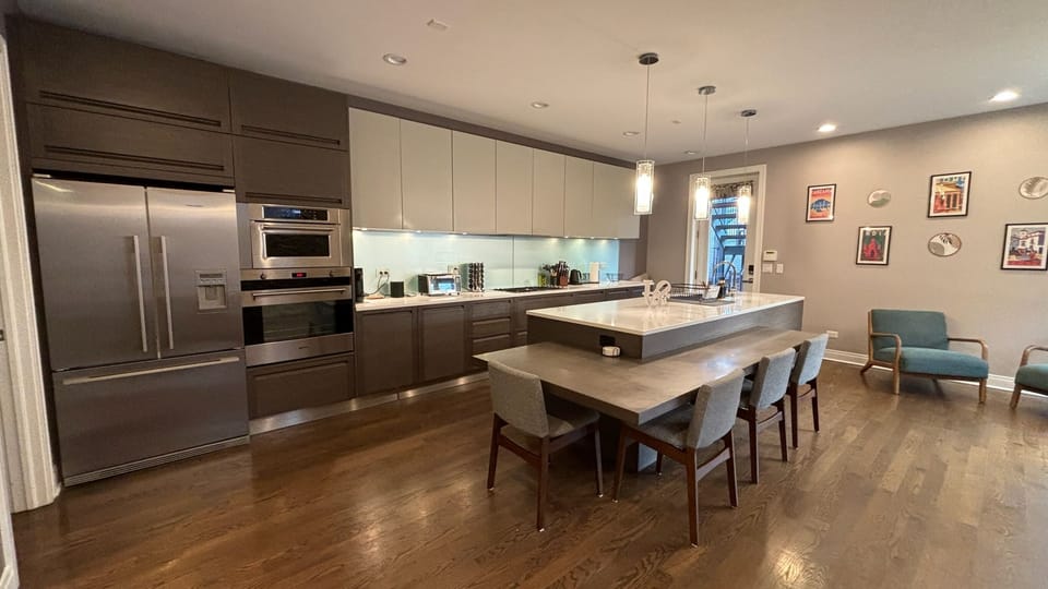 Huge kitchen, with large island, fireplace and standing desk. Lots of light!