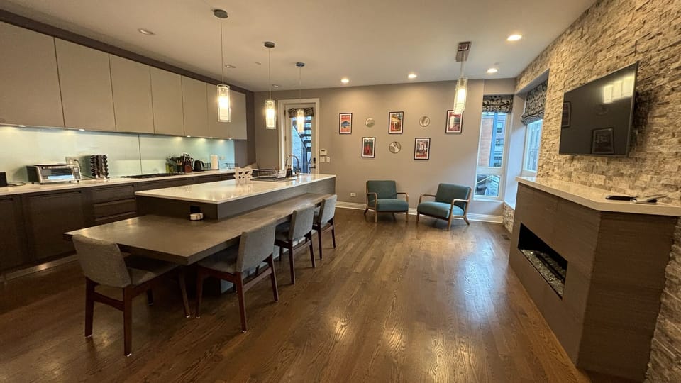 Huge kitchen, with large island, fireplace and standing desk. Lots of light!