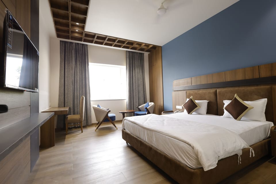 Premium bedding, desk, laptop workspace, blackout drapes