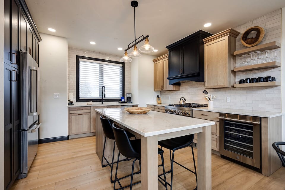 Your gourmet kitchen features sleek quartz countertops, modern appliances, and a perfect island for cooking and casual dining together.