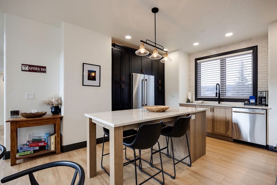 Your stylish kitchen features sleek countertops, modern appliances, and a cozy breakfast bar where you can savor morning coffee together.