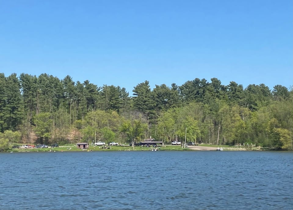 People swimming and boating at Pineview Park, a public beach, park, boat landing