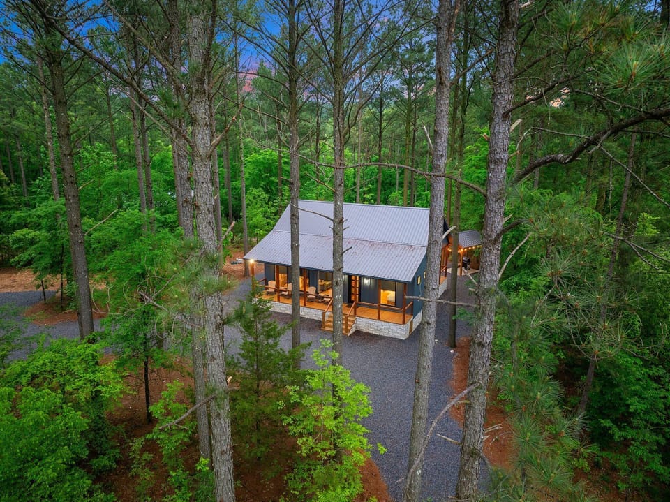 Nestled among towering pines, enjoy serenity and stunning views from the porch