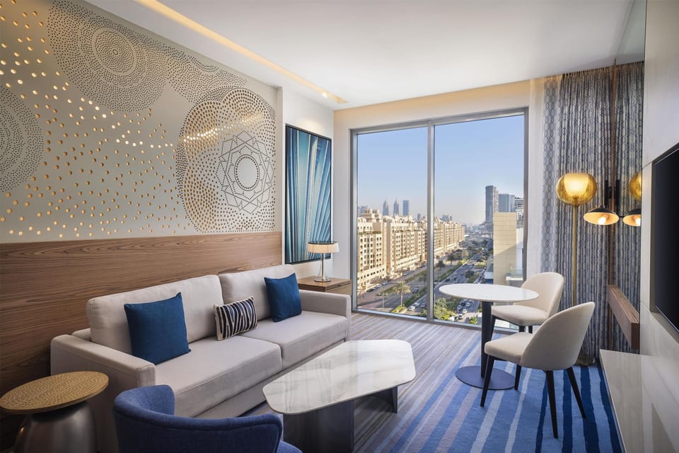 Suite, 1 King Bed, Balcony | Living area | 49-inch TV with digital channels