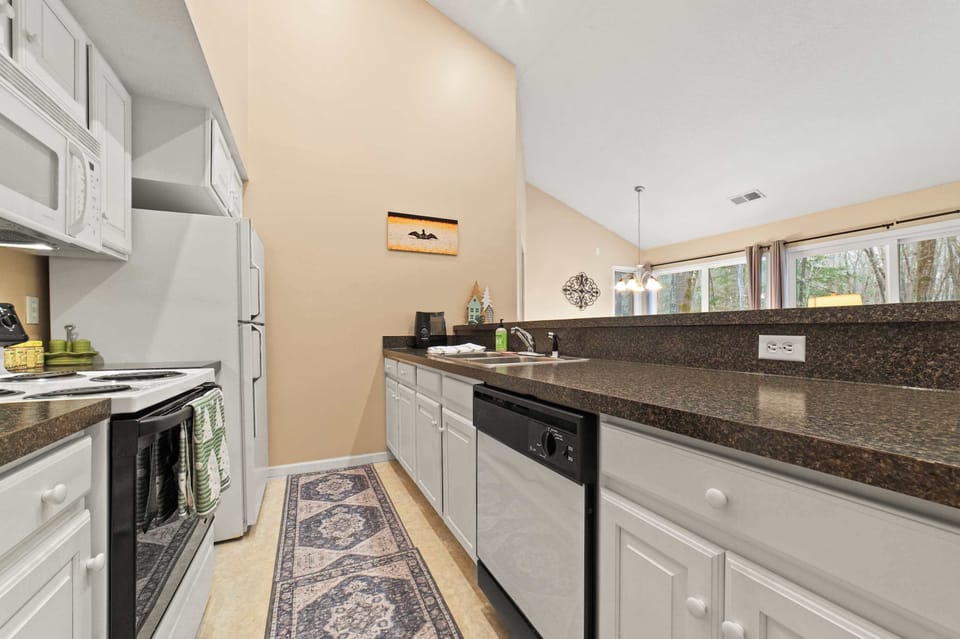 Spacious kitchen with all of the dishes, spices and amenities needed.