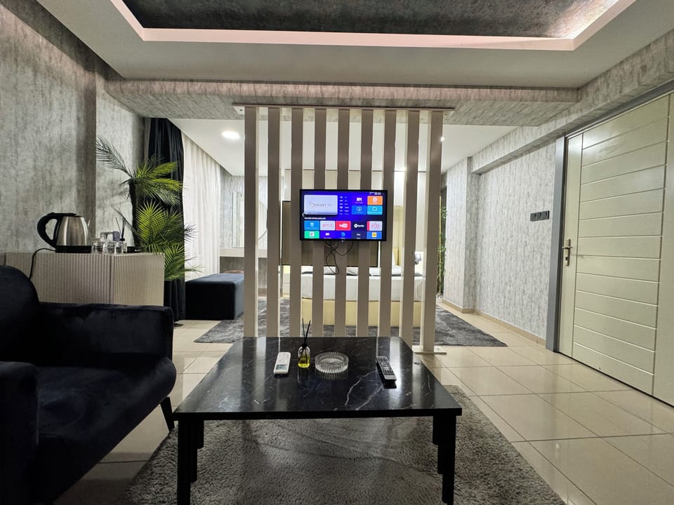 Superior Triple Room, City View | Living area | TV