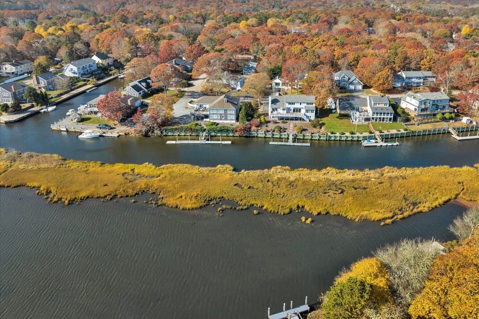 A stunning aerial view of the waterfront community in full autumn splendor.