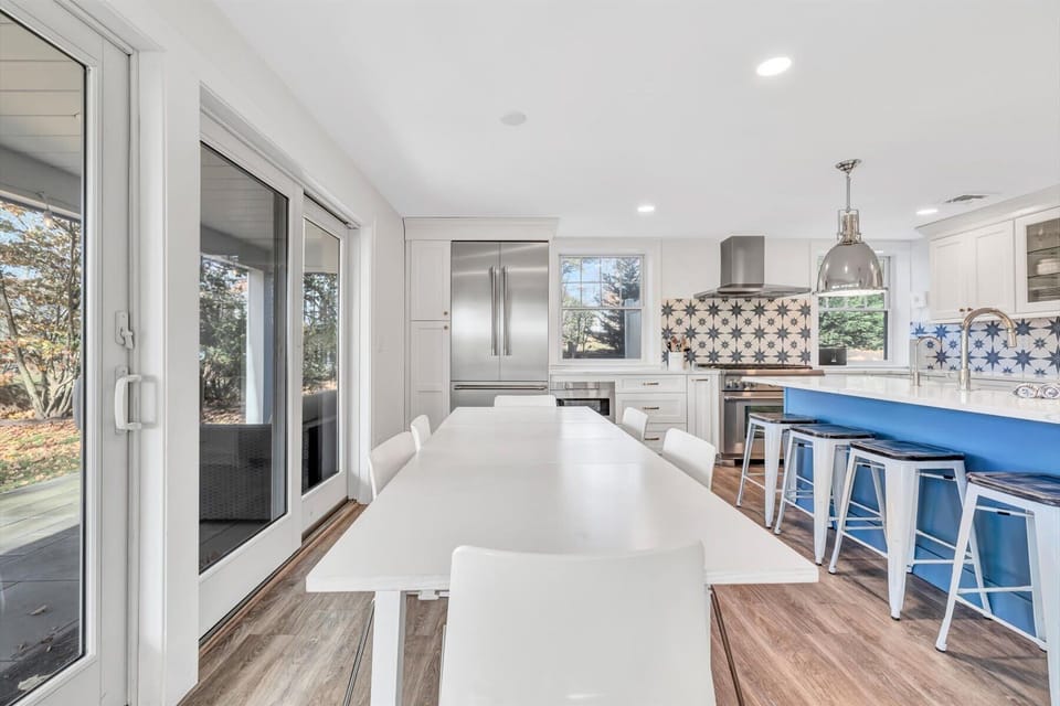 Dining area with ample seating, seamlessly connecting to the kitchen and outdoor spaces.